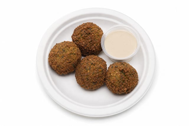 4 Falafel Balls with Tahini on Side.